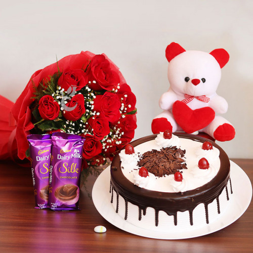 Pampering Surprise: A Gift Combo of 10 red roses, 2 Cadbury Dairy Milk Silk, 0.5 Kg Black Forest cake and 6 inch teddy bear