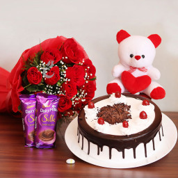 Pampering Surprise: A Gift Combo of 10 red roses, 2 Cadbury Dairy Milk Silk, 0.5 Kg Black Forest cake and 6 inch teddy bear
