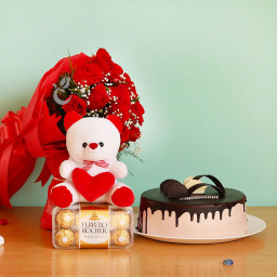 Romantic Zeal: A Gift Combo of 10 red roses bouquet, 6-inch soft toy, Ferrero Rocher and 0.5 kg chocolate cake Romantic Zeal: A Gift Combo of 10 red roses bouquet, 6-inch soft toy, Ferrero Rocher and 0.5 kg chocolate cake