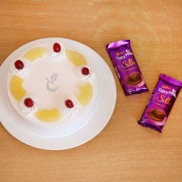 Sweet Castle: A Gift Combo of 2 Dairy Milk Silk and 0.5 Kg Pineapple Cake Sweet Castle: A Gift Combo of 2 Dairy Milk Silk and 0.5 Kg Pineapple Cake