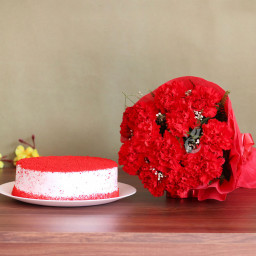 Red Love Story: A Gift Combo of 12 Carnations and 0.5 Kg Red Velvet Cake Red Love Story: A Gift Combo of 12 Carnations and 0.5 Kg Red Velvet Cake